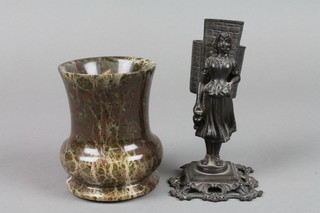 A 19th Century Continental bronze match striker in the form of a standing girl with panier 4 1/2" , together with at turned serpentine vase 3" 