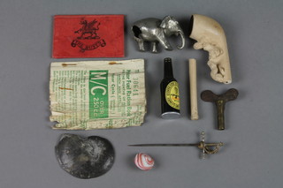 An 18th/19th Century clay pipe the head decorated a lady, a Guinness novelty table lighter, fuel coupons, a military pass (the BUFFS) dated 1894, a section of ammonite 