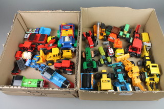 2 shallow boxes containing model tractors etc