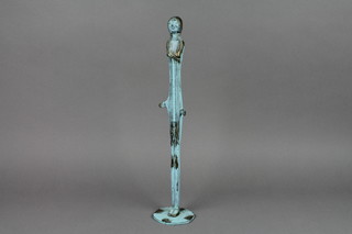 A verdigris bronze figure of a standing lady, raised on a circular base 15"