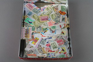 A tin containing a collection of various Commonwealth stamps, including high value, mainly George VI