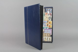 A blue stock book of various world stamps