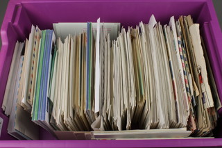 A purple crate containing a collection of first day covers