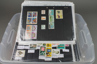 A crate of various World, Commonwealth and European stamps some on album/stock pages