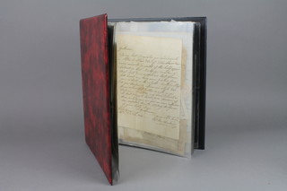 A loose leaf album containing various Victorian envelopes with penny red stamps, a Georgian letter to the Lord Chancellor dated 1808 and various other letters, stamped envelopes etc