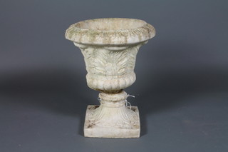 A square carved and fluted marble urn base with reconstituted trumpet shaped garden urn to the top 25"h x 17"