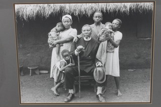 A black and white photograph of an African clergyman and family 18" x 23 1/2" 