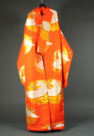 A 20th Century orange embroidered silk kimono decorated storks