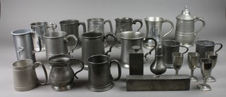 A collection of various pewter tankards