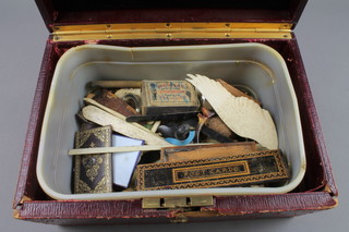 A Victorian red leather jewellery box containing a containing an ivory clothes brush and a collection of various sections of carved ivory 