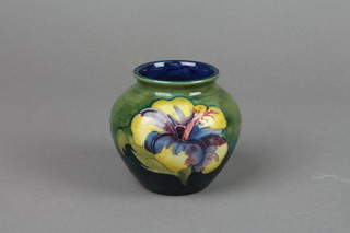 A 1940's Walter Moorcroft baluster vase, the green blue ground decorated hibiscus 3"
