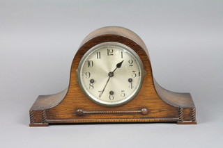 A 1930's chiming mantel clock with silvered dial and Arabic numerals contained in an oak Admiral's hat shaped case