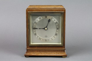 An Elliott timepiece with Roman numerals contained in a walnut case