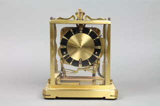 A brass cased Shatz clock on raised platform, 8"