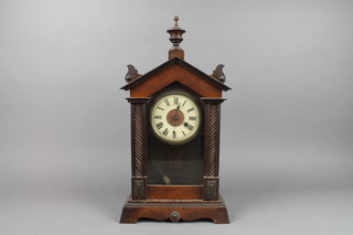 A 19th Century American shelf clock with metal dial and Arabic numerals contained in a walnut case