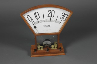 Reynolds & Branson Ltd, a voltmeter no.57368B, contained in an oak Art Deco fan shaped case 