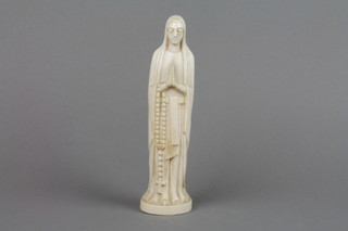 An antique carved ivory figure of a nun in supplication holding a rosary 8"