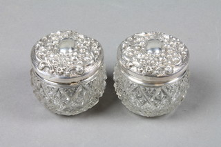 A pair of cut glass silver mounted toilet jars 2" 