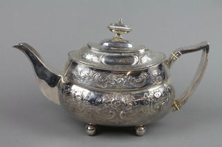 A George III silver teapot, the bulbous body with repousse scroll and floral decoration and urn finial on ball feet, London 1812, maker SH, approx 16 ozs