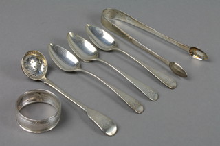 A Georgian silver sifter spoon, 3 others, a pair of nips and a napkin ring