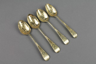 A set of 4 Victorian silver gilt dessert spoons with chased decoration, London 1842