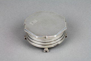 An Art Deco silver trinket box with stepped sides on scroll feet, Birmingham 1938