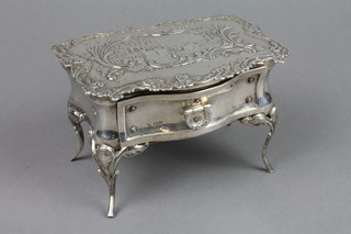 An Edwardian silver miniature 1 drawer table, with repousse decoration with a country house garden and scroll border, on cabriole legs with shell knees, London 1904 5.5"  