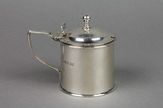 A George III silver circular mustard pot with scroll handle and blue glass liner, London 1817