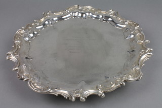 A silver salver with fancy scroll rim on scrolled feet, approx. 27 ozs, 13"