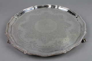 A Victorian silver salver with beaded rim and formal engraved decoration on claw and ball feet Sheffield 1876, approx 21 ozs, 12.5"