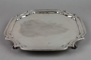 A silver salver with Chippendale style rim engraved with signatures on scroll feet, Sheffield 1944, approx. 30 ozs, 12"
