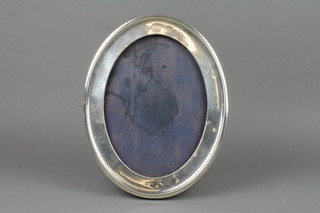 An oval silver photograph frame, Birmingham 1949, opening 10.5" x 7.5" 
