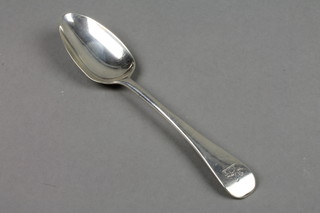 A Georgian silver table spoon with engraved crest