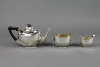 A bachelor's silver teaset with demi-fluted decoration and ebony mounts, Birmingham 1902, 1904 and 1905, gross weight approx. 13 1/2 ozs 