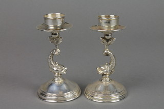 A pair of Continental Sterling silver dwarf candlesticks with dolphin stems and splayed bases 4"