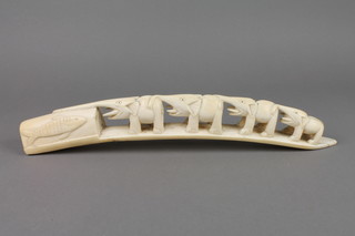 A carved ivory tusk with a procession of elephants 16"