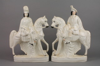 A pair of Victorian Staffordshire mounted highlanders with dead deer on raised bases 16"