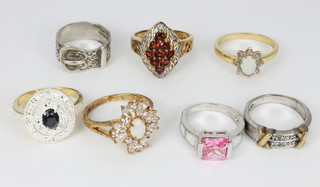 An Edwardian silver buckle ring and 6 other rings