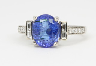 An 18ct white gold tanzanite and diamond ring, the centre stone approx 2.73ct, flanked by 2 baguette diamonds and 5 brilliant cut diamonds to each shoulder