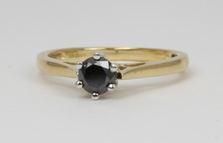 An 18ct black diamond single stone claw set ring