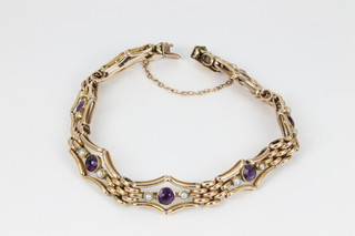 An Edwardian 9ct gold amethyst and seed pearl open bracelet, gross 13.2grams 