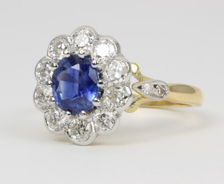 An 18ct yellow gold sapphire and diamond ring the oval sapphire approx 1.40ct surround by 10 brilliant cut diamonds approx 0.95ct 