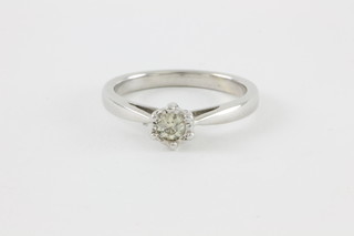 A white gold single stone diamond ring in a rub over setting, approx 0.15ct