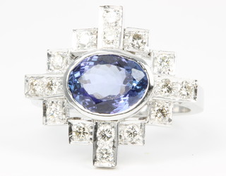A white gold tanzanite and diamond Art Deco style ring, the oval centre stone approx. 2.75ct, surrounded by 16 brilliant cut diamonds 