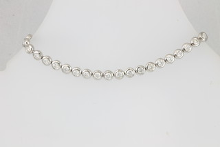 An 18ct white gold rub over set diamond bracelet, set with 32 brilliant cut stones, approx 4.85ct