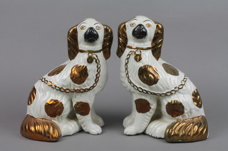 A pair of 19th Century Staffordshire figures of seated spaniels with gilt decoration 10" 