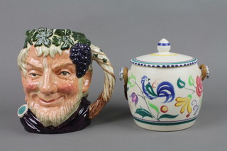 A 1960's Poole biscuit barrel and cover decorated with stylised birds and flowers with wicker handle 7" and a Royal Doulton character jug - Bacchus E6499 8"
