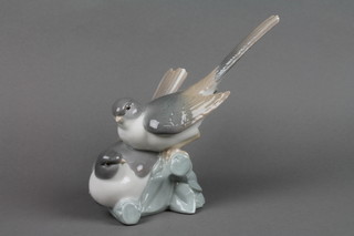 A Lladro group of swallows on a rocky base 7"