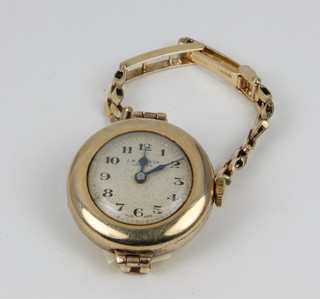 A 9ct gold wristwatch inscribed Benson on a ditto bracelet with spare links