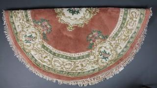 An Indian pink ground and floral patterned circular rug  73" diam. 